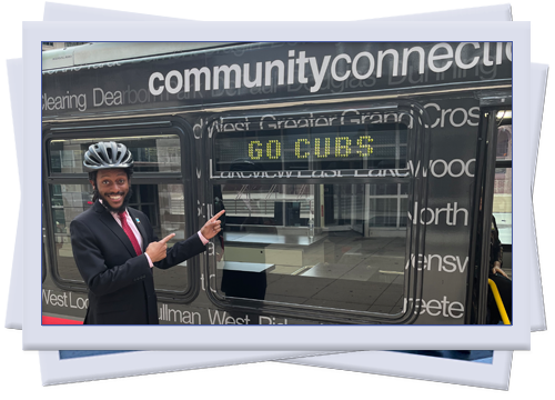 Mike points at a sign on the side of a public transit bus that says "Go Cubs"