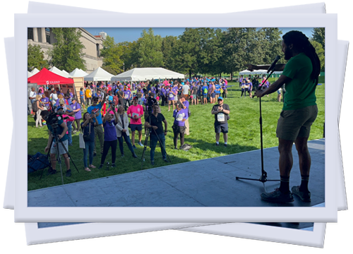 Mike speaking to a crowd gathered at a festival