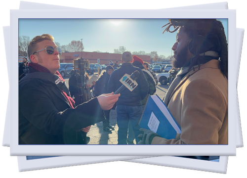 Mike speaking to a reporter